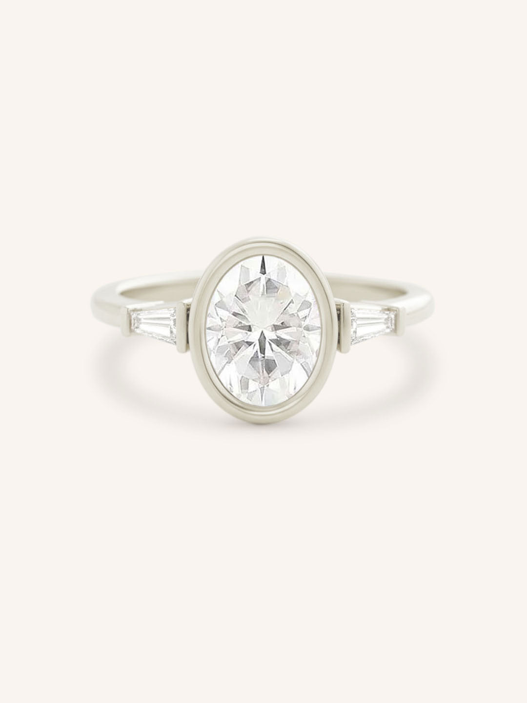 White gold Grannis three stone oval and baguette diamond engagement ring front view on white background