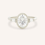 White gold Grannis three stone oval and baguette diamond engagement ring front view on white background