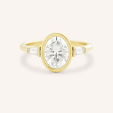 Yellow gold Grannis three stone oval and baguette diamond engagement ring front view on white background