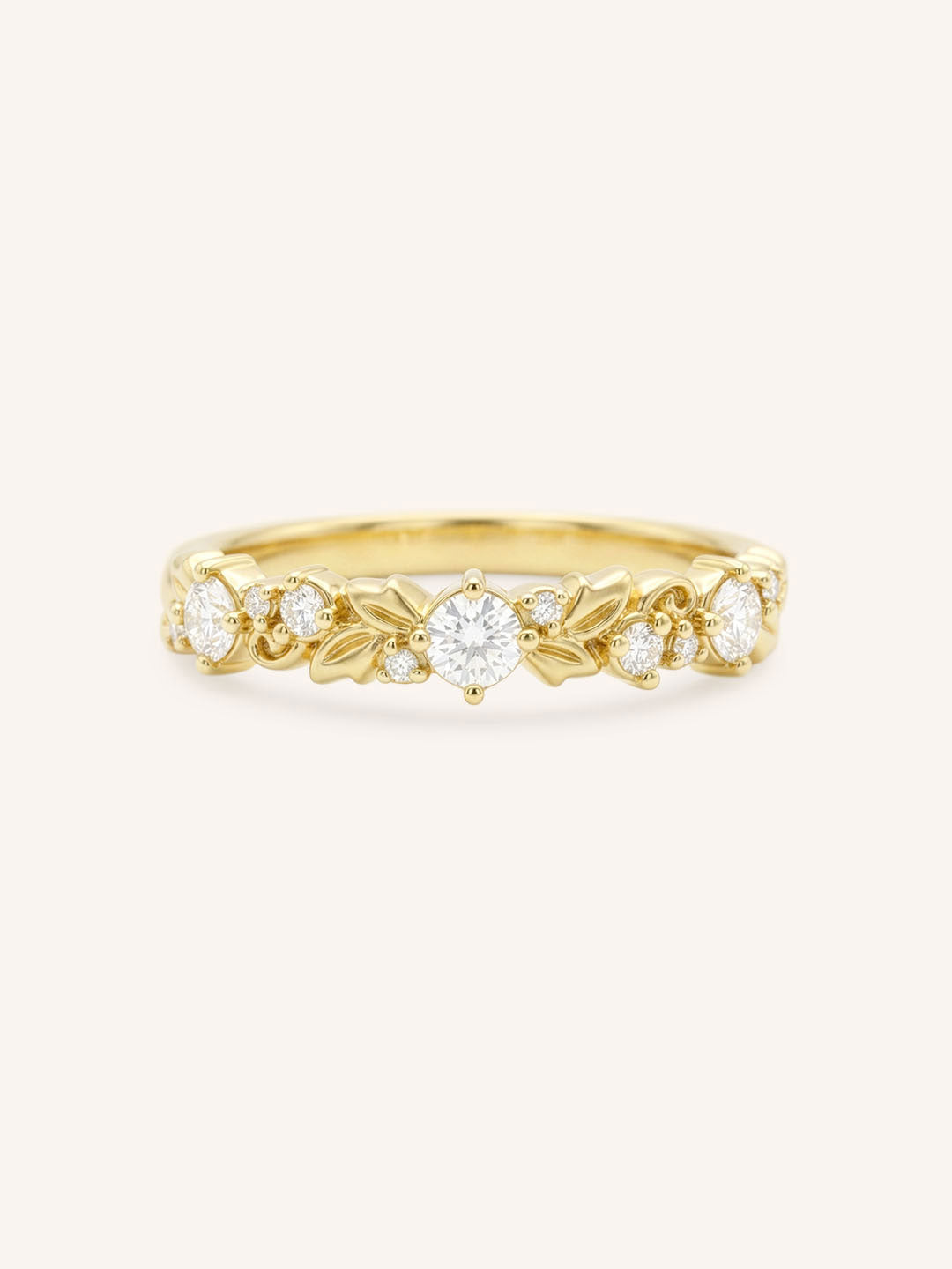 Gold ring with diamond accents on a white background
