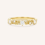 Gold ring with diamond accents on a white background