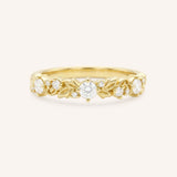 Gold ring with diamond accents on a white background