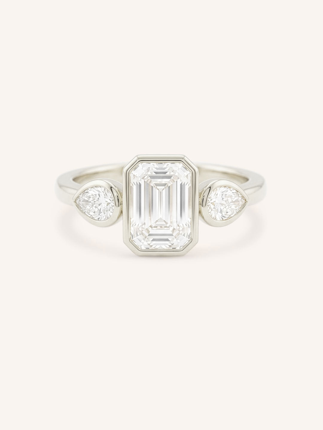 Jessie Emerald Cut and Pear Diamond Bezel Three Stone Engagement Ring