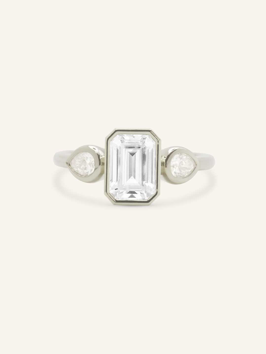 Jessie Emerald Cut and Pear Diamond Bezel Three Stone Engagement Ring