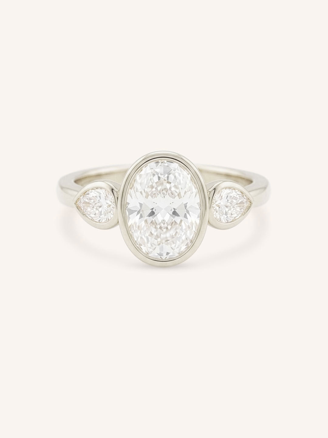 Jessie Oval and Pear Diamond Bezel Three Stone Engagement Ring
