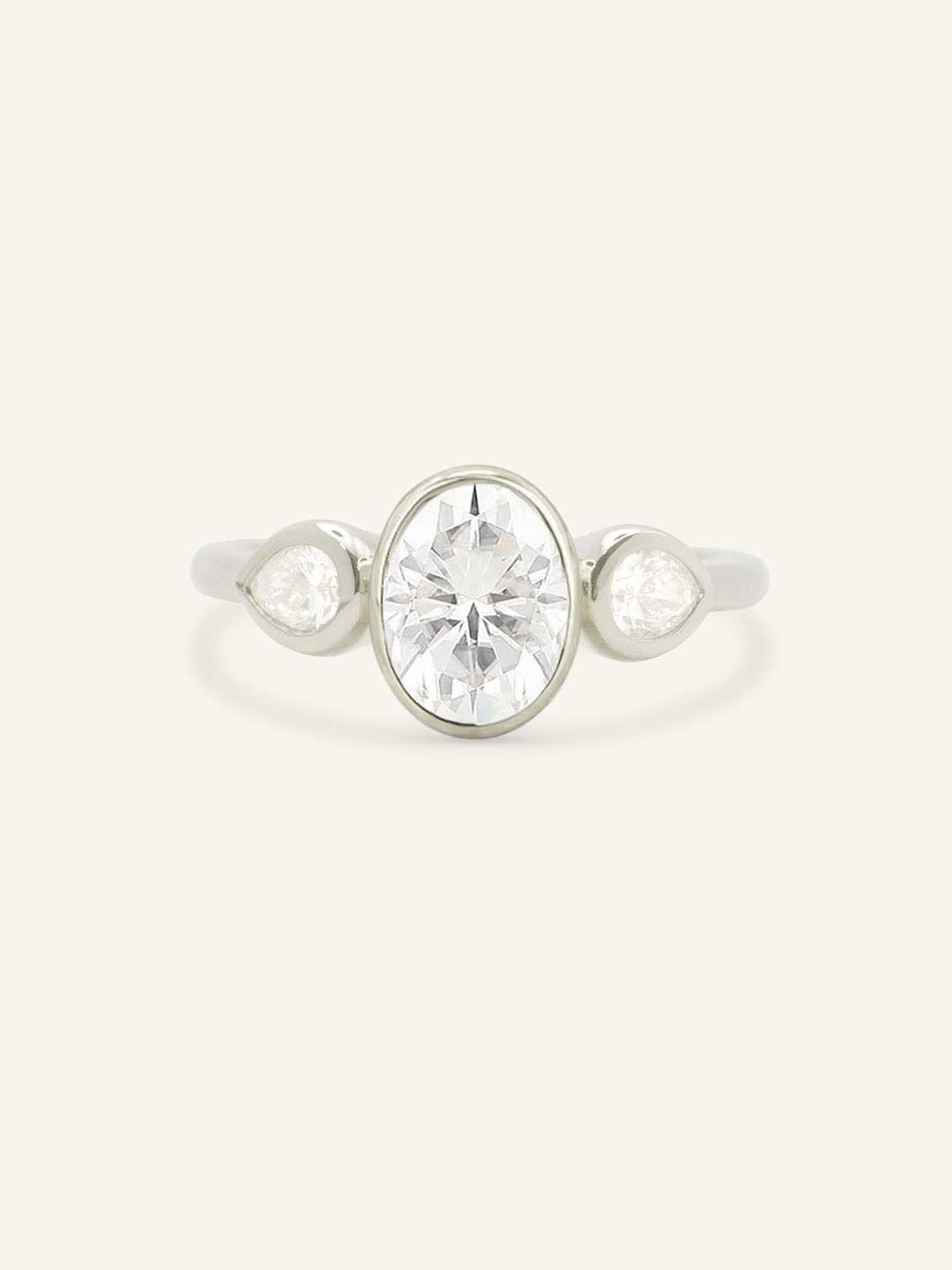 Jessie Oval and Pear Diamond Bezel Three Stone Engagement Ring