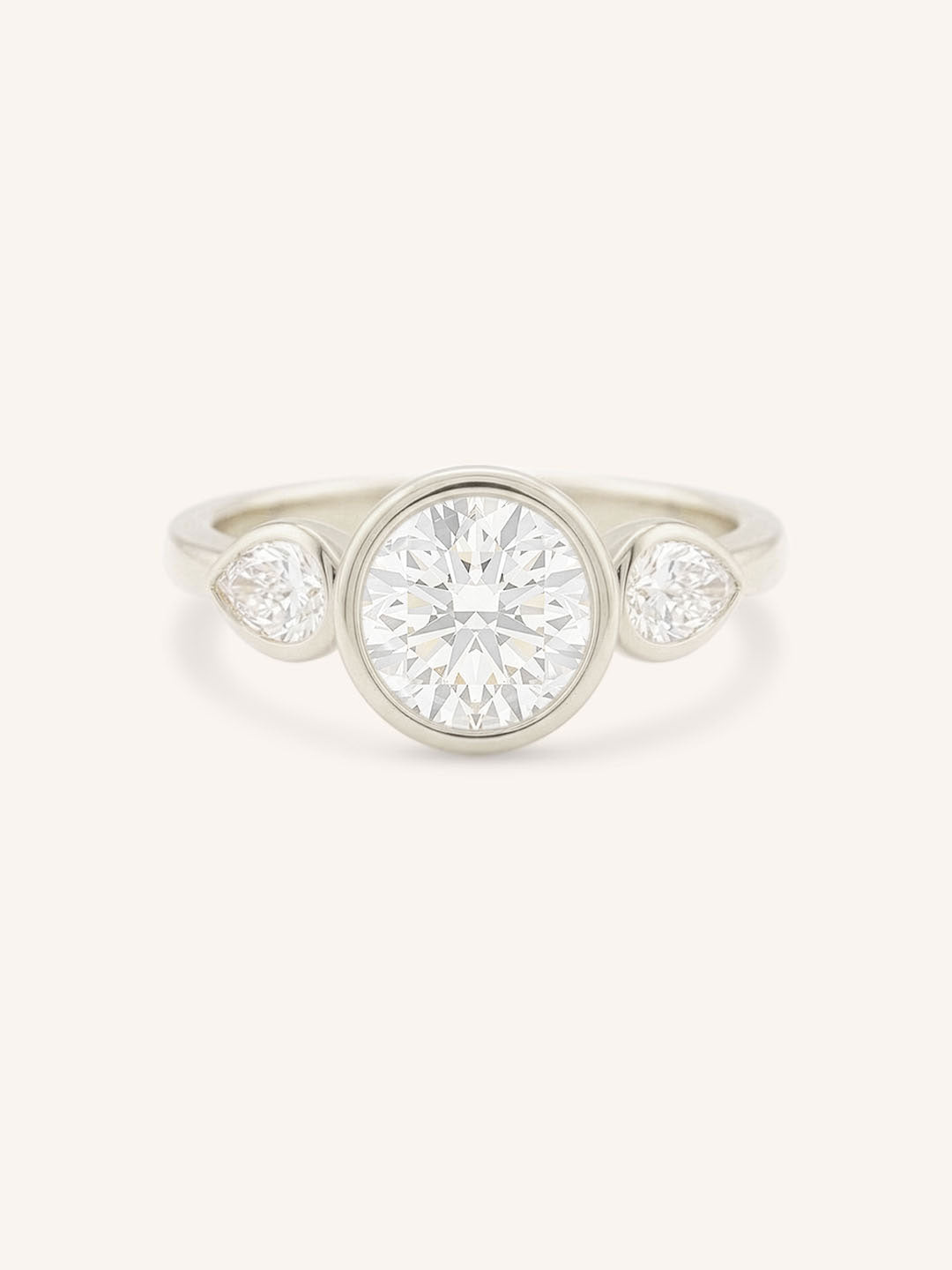 Jessie Round and Pear Diamond Bezel Three Stone Engagement Ring