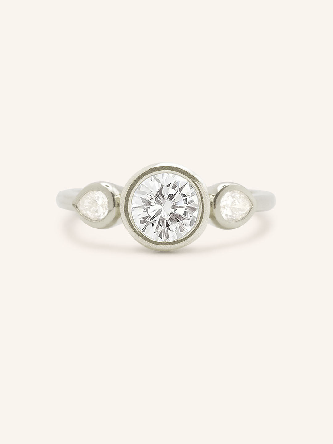 Jessie Round and Pear Diamond Bezel Three Stone Engagement Ring