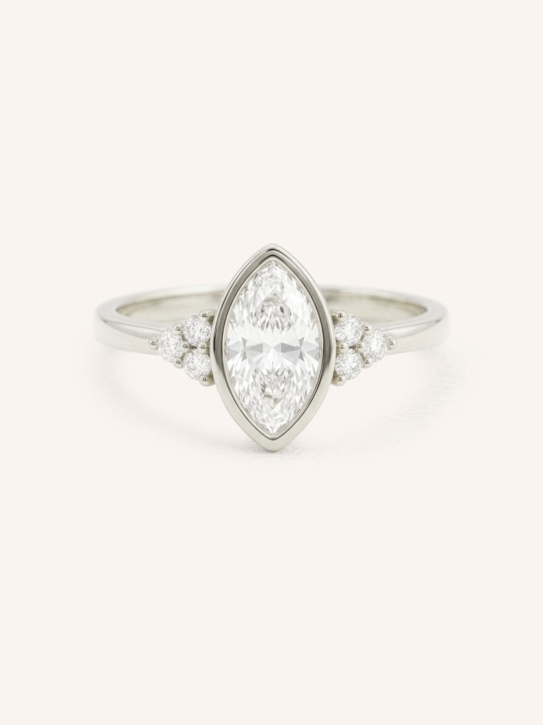 White gold marquise cut bezel set diamond engagement ring with side stones on white background