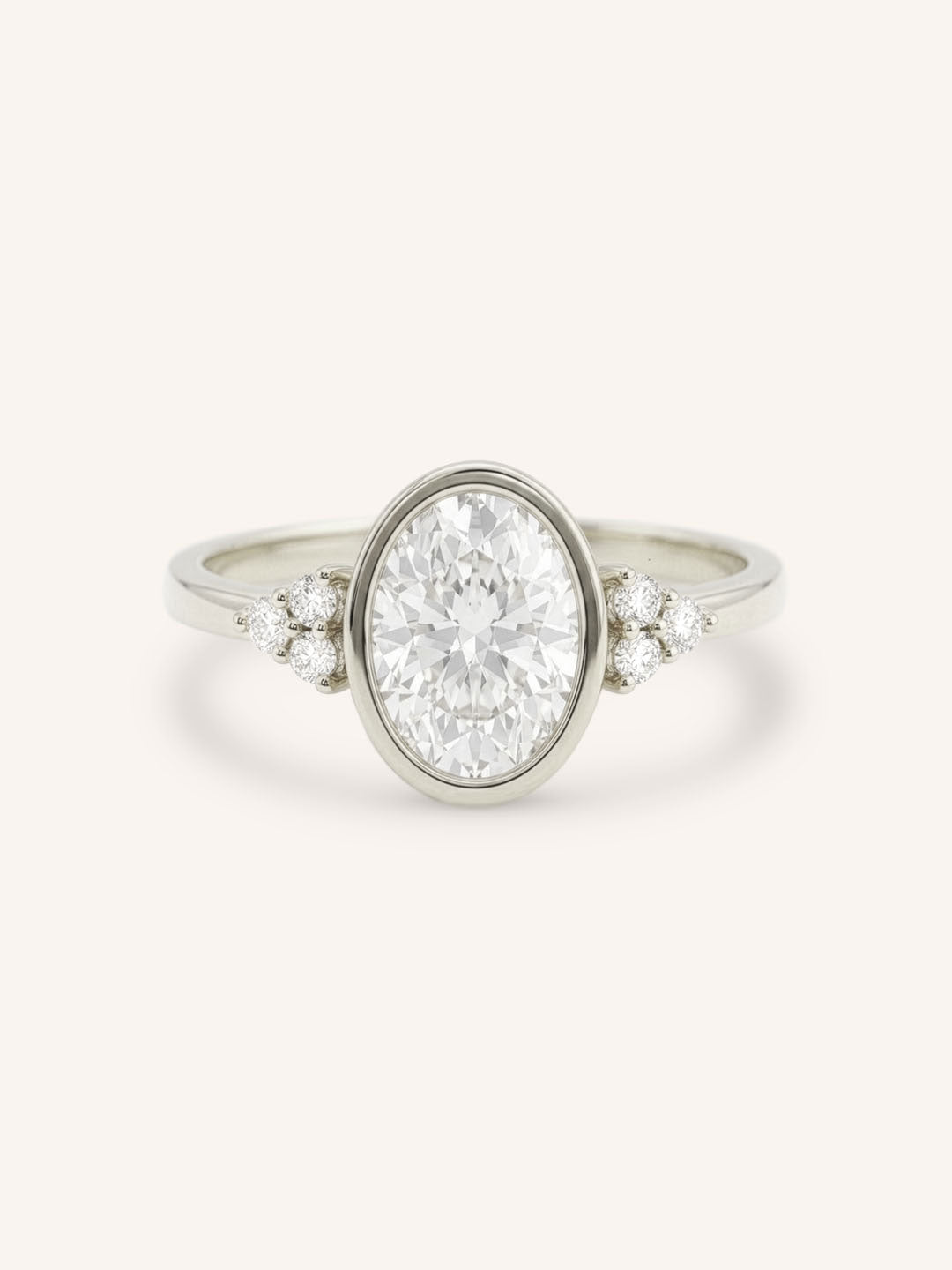 White gold oval cut bezel set diamond engagement ring with side stones on white background