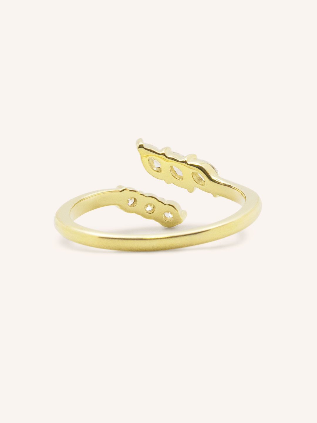 Yellow gold round and marquise open diamond bypass ring back view on white background