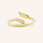Yellow gold round and marquise open diamond bypass ring back view on white background