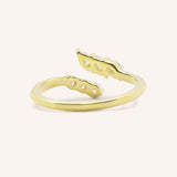 Yellow gold round and marquise open diamond bypass ring back view on white background