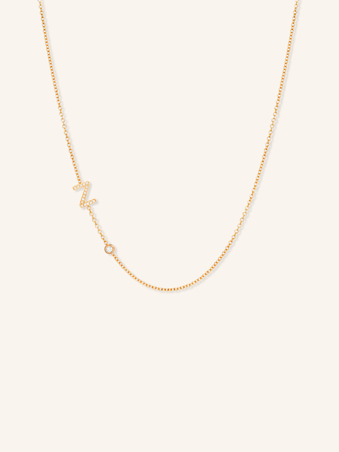 Rose gold asymmetrical diamond initial Z and bezel necklace on white background