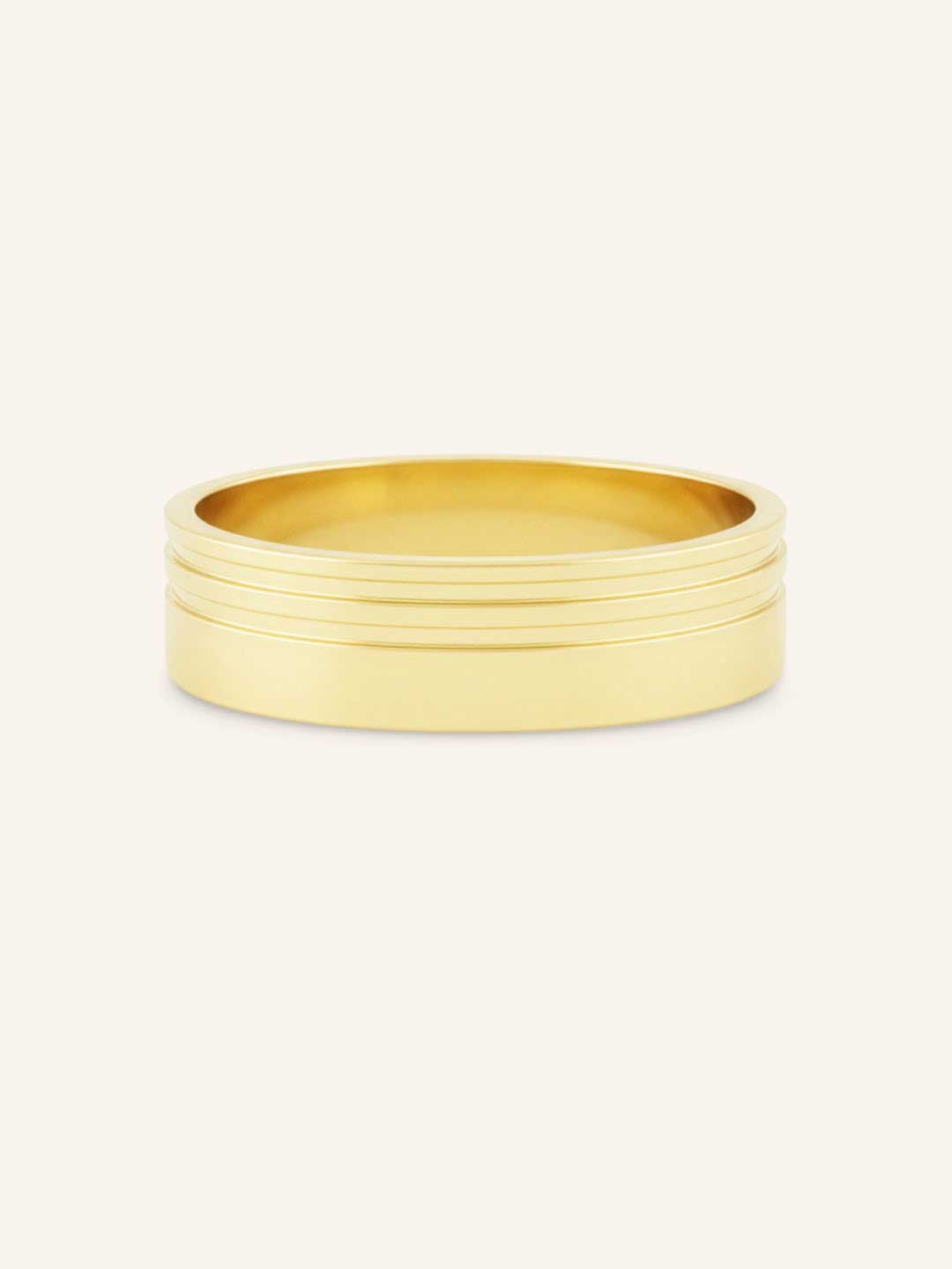 Gold ring with multiple bands on a white background