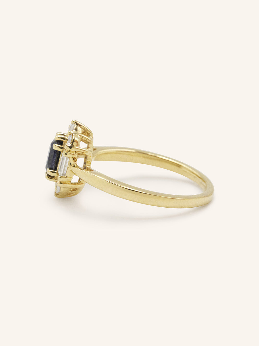 Yellow gold Wyona oval blue sapphire halo-style ring side view on white background