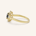 Yellow gold Wyona oval blue sapphire halo-style ring side view on white background