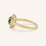 Yellow gold Wyona oval blue sapphire halo-style ring side view on white background