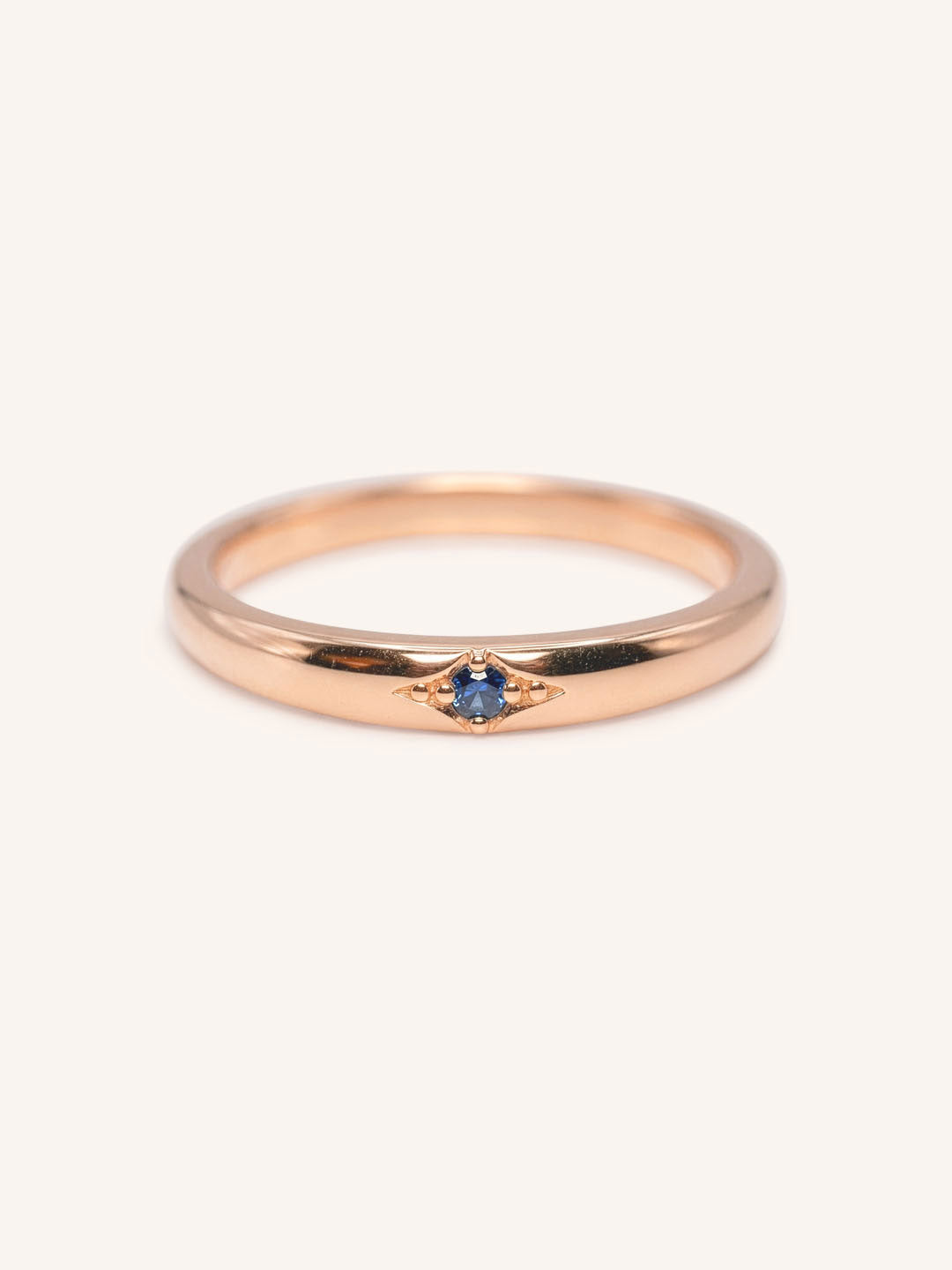 Rose gold Beacon blue sapphire stackable ring front view on white background