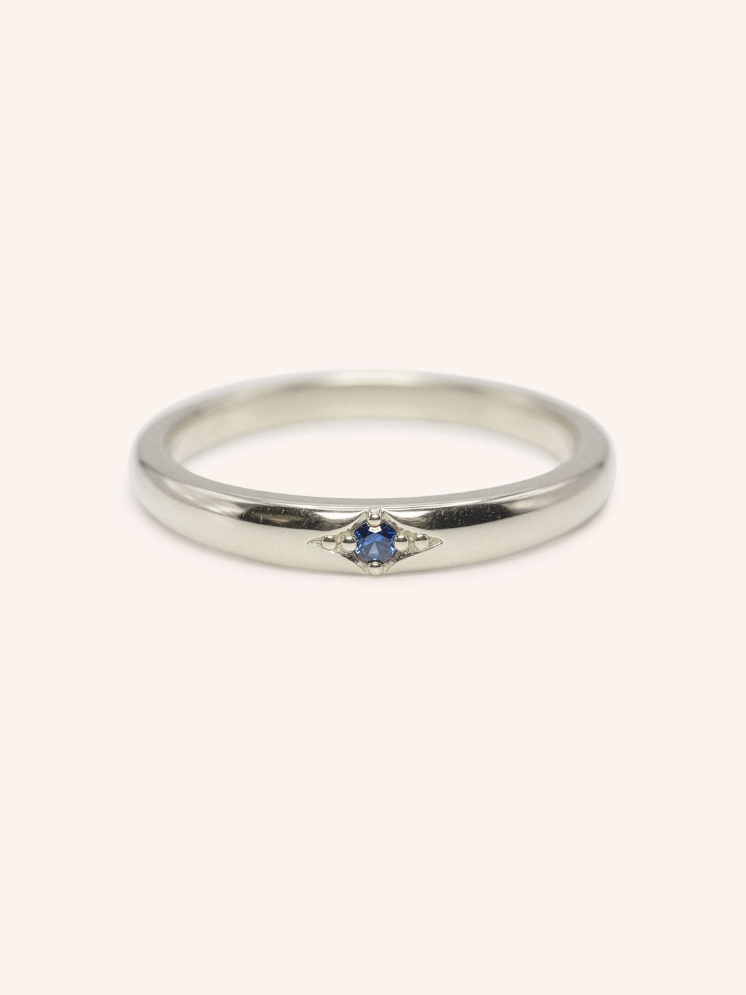 White gold Beacon blue sapphire stackable ring front view on white background