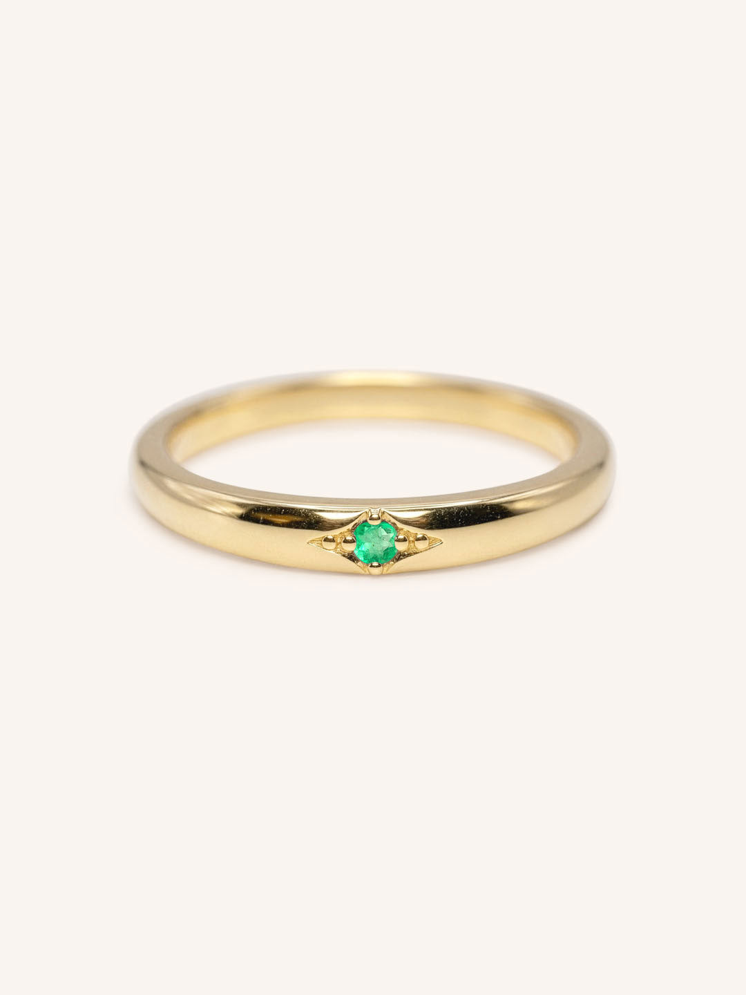 Yellow gold Beacon emerald stackable ring front view on white background