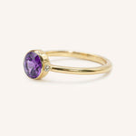 Yellow gold amethyst and diamond ring side view on white background