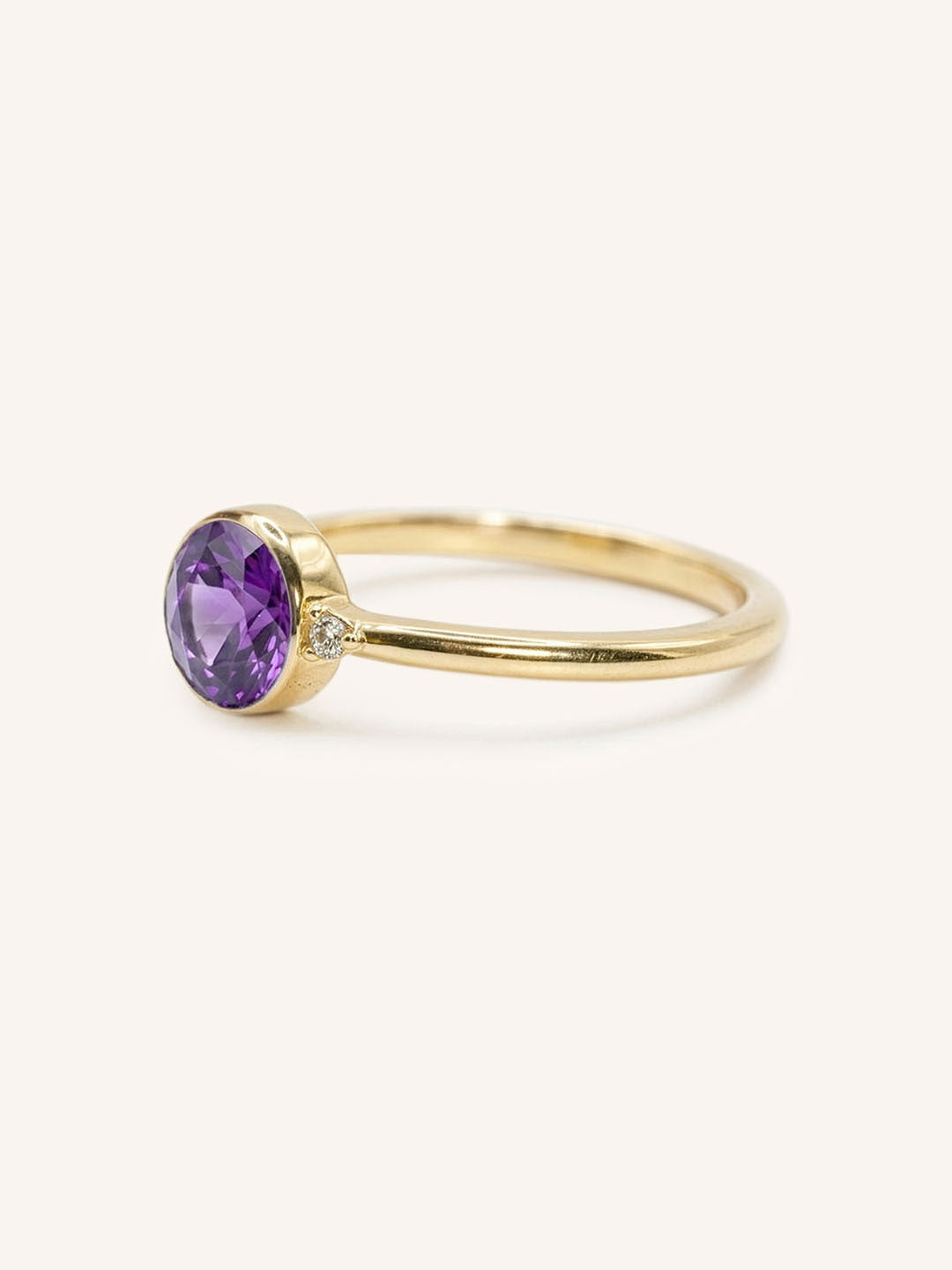 Yellow gold amethyst and diamond ring side view on white background