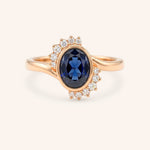 Rose gold Marlowe oval blue sapphire cluster diamond ring front view on white background