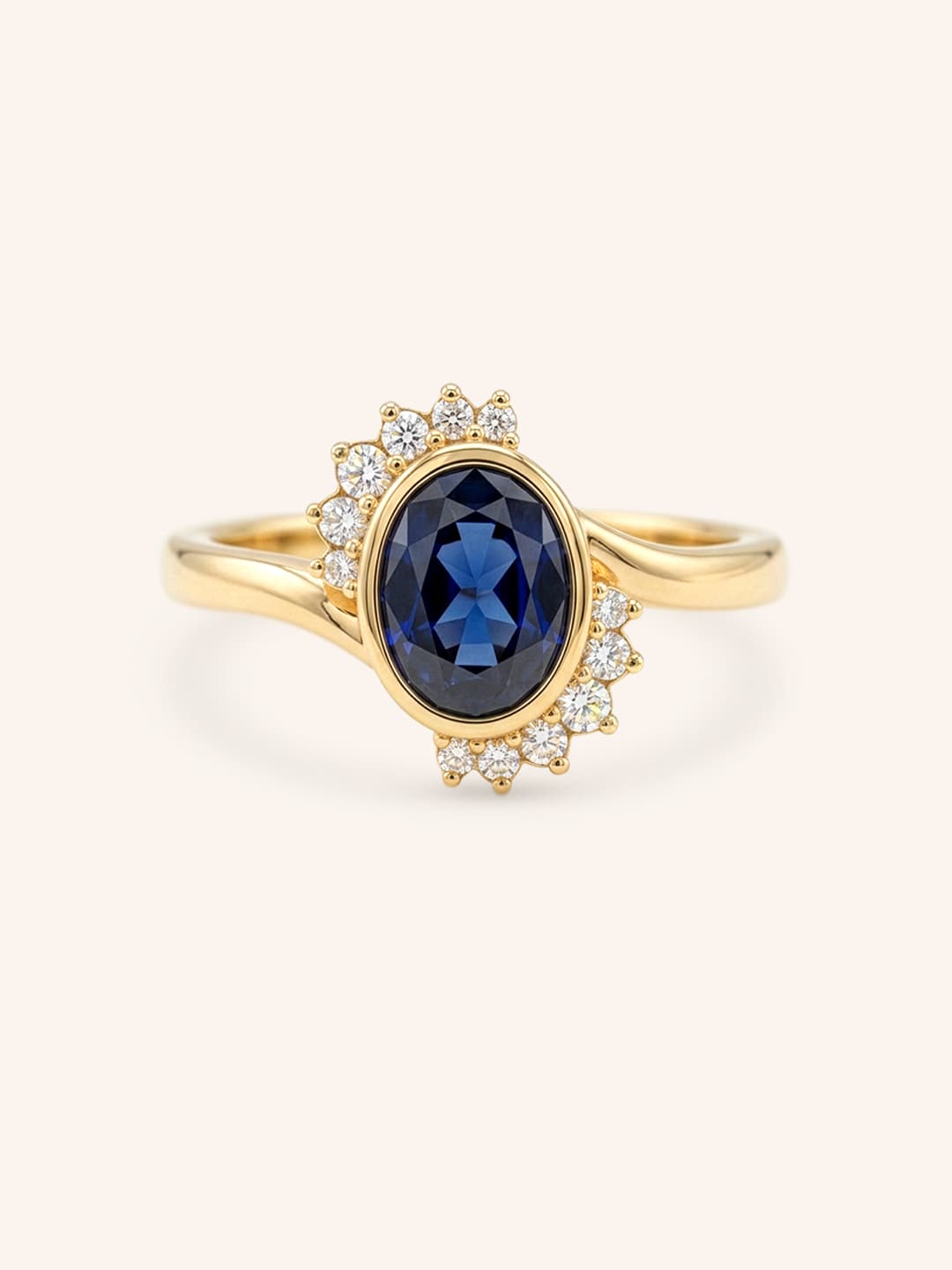Yellow gold Marlowe oval blue sapphire cluster diamond ring front view on white background