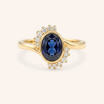 Yellow gold Marlowe oval blue sapphire cluster diamond ring front view on white background