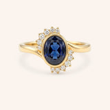 Yellow gold Marlowe oval blue sapphire cluster diamond ring front view on white background