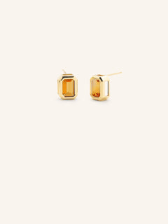 Yellow gold Milly emerald cut lab citrine solitaire earrings on white background