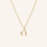 A gold-colored necklace in the shape of a wishbone.