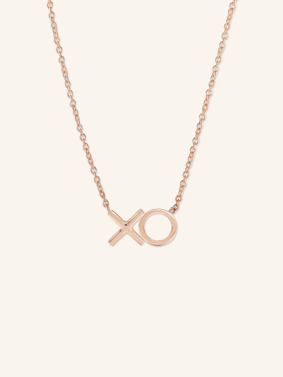 Rose gold XO hugs and kisses pendant necklace on white background