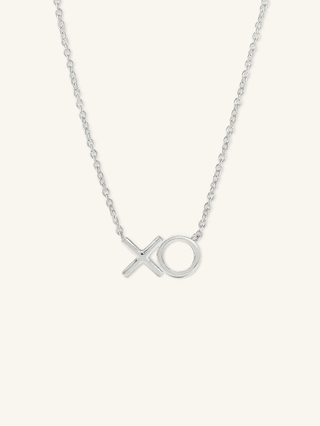 White gold XO hugs and kisses pendant necklace on white background