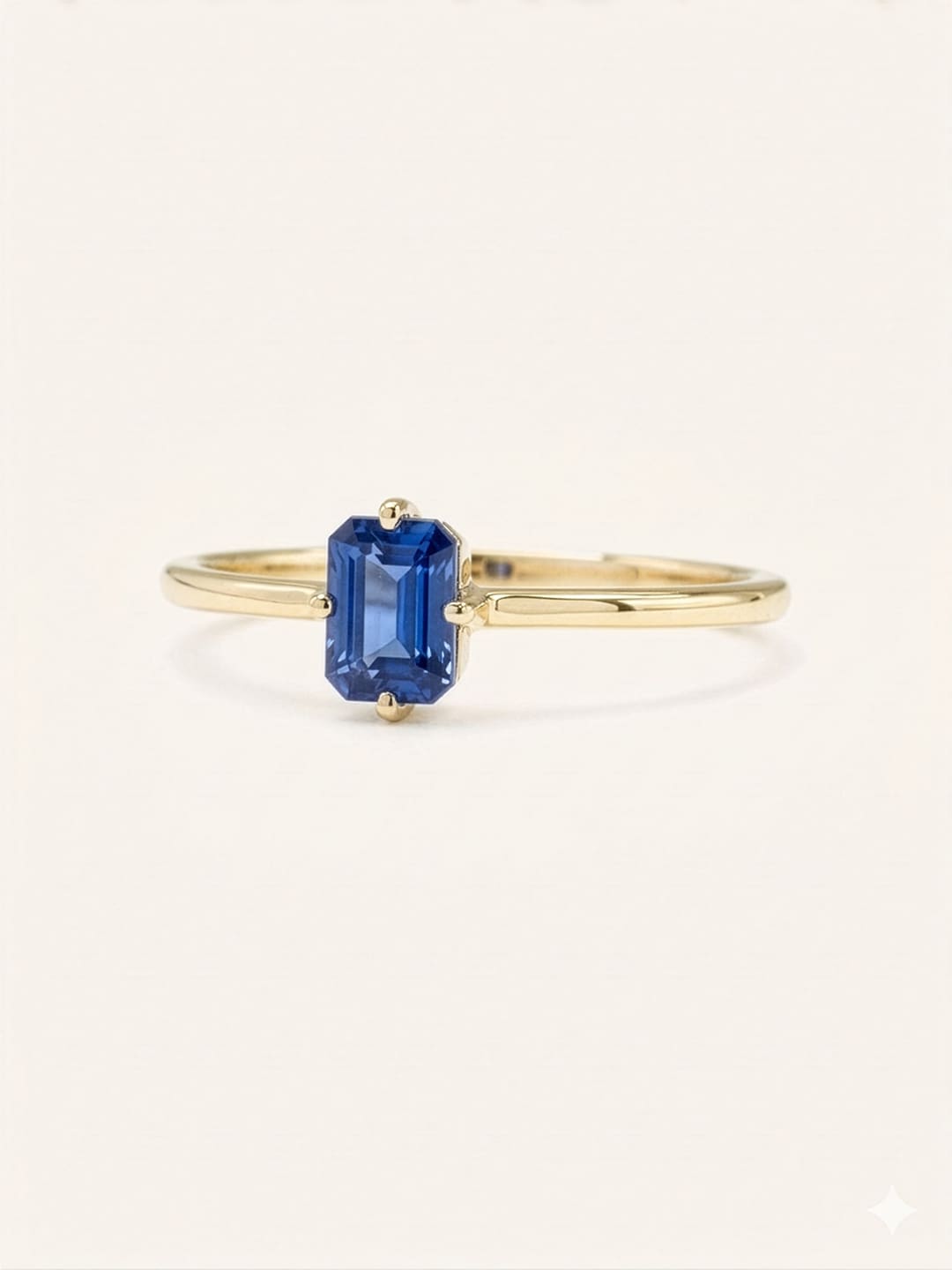 Yellow gold Daylily blue sapphire ring side view on white background