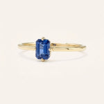 Yellow gold Daylily blue sapphire ring side view on white background