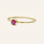 Yellow gold Autumn Lane ruby ring side view on white background