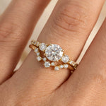 Close-up of hand wearing yellow gold Twinkle diamond ring stacked with wedding band
