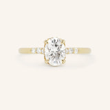 Yellow Gold Hidden Halo Oval Moissanite Engagement Ring with Diamond Accents front view on white background