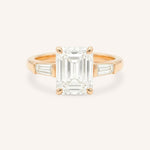Rose gold Stately Manor emerald cut diamond three stone engagement ring with baguette accents front view