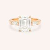 Rose gold Stately Manor emerald cut diamond three stone engagement ring with baguette accents front view