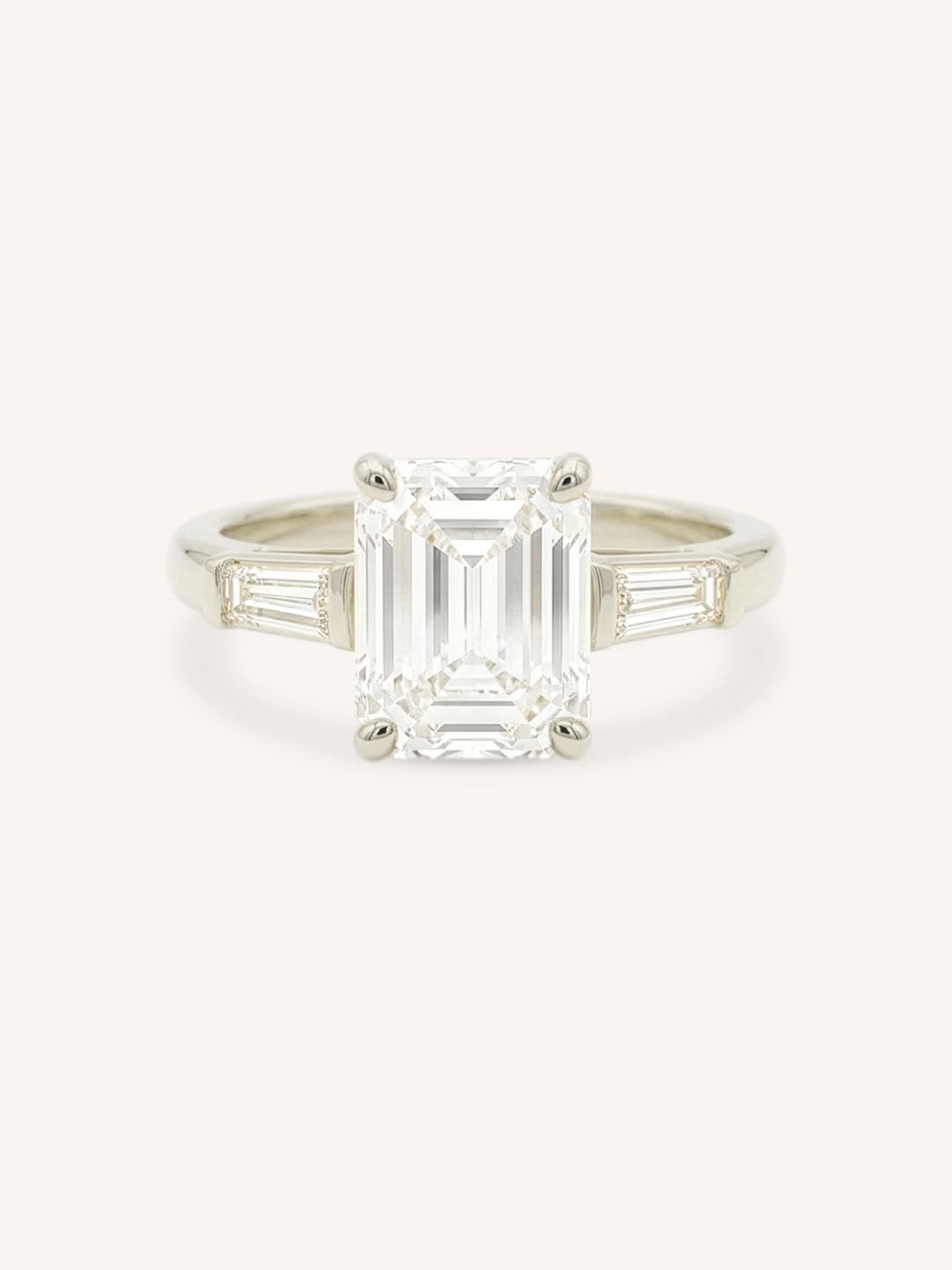 White gold Stately Manor emerald cut diamond three stone engagement ring with baguette accents front view