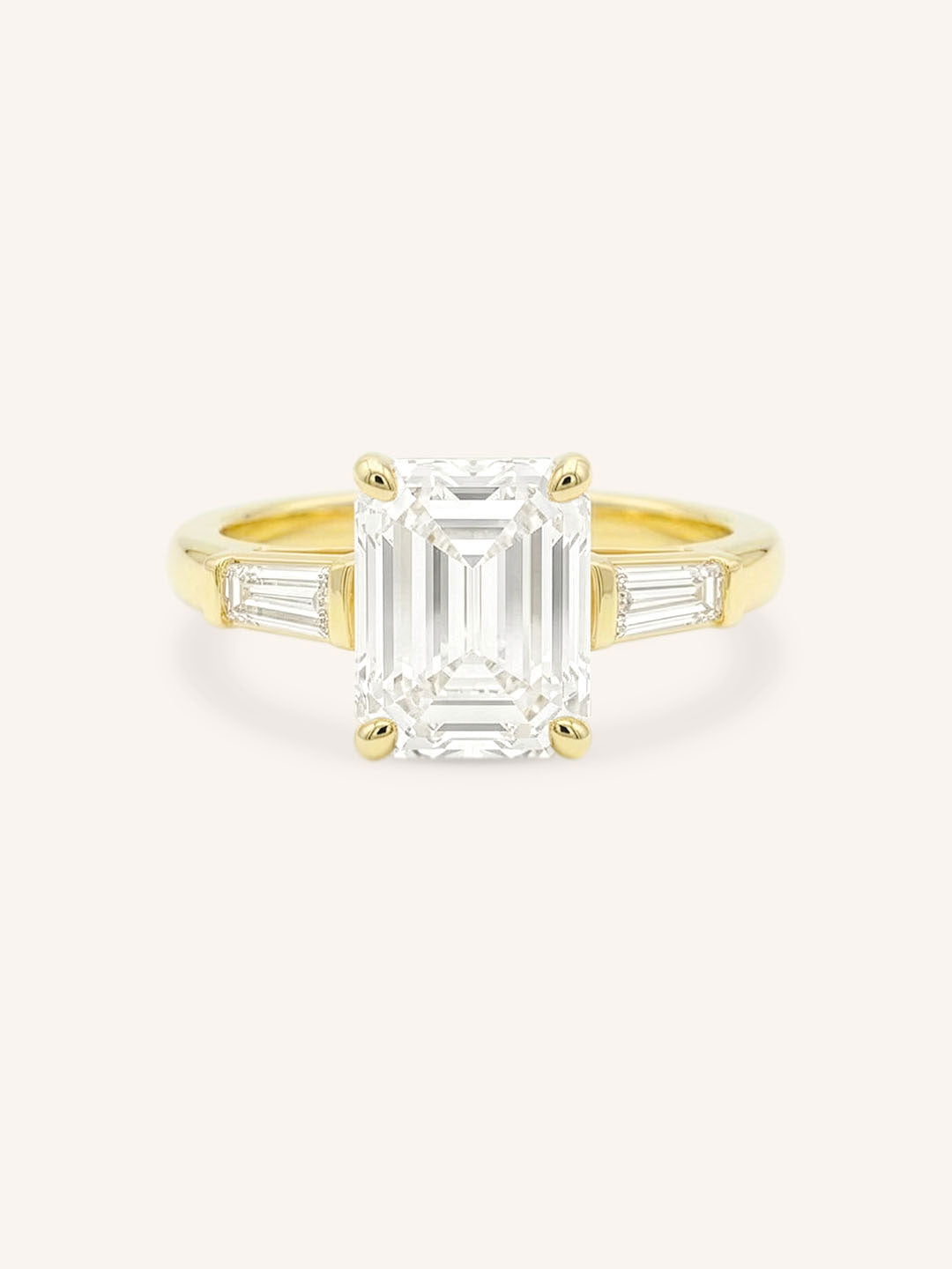 Yellow gold Stately Manor emerald cut diamond three stone engagement ring with baguette accents front view