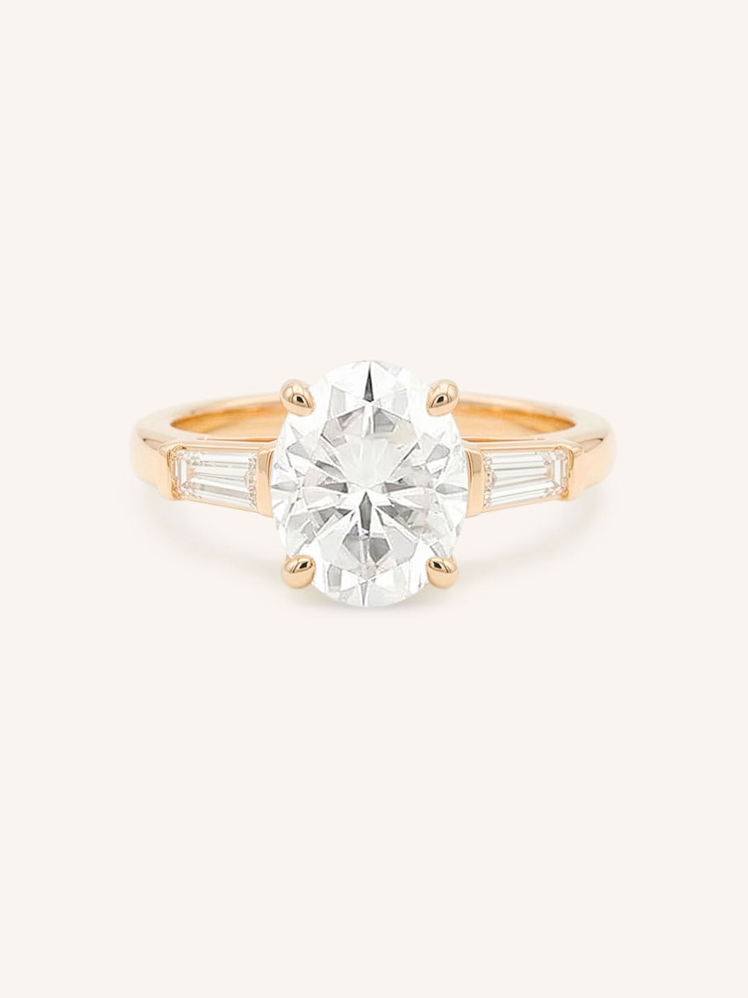 Rose gold Stately Manor oval diamond three stone engagement ring with baguette accents front view