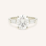 White gold Stately Manor oval diamond three stone engagement ring with baguette accents front view
