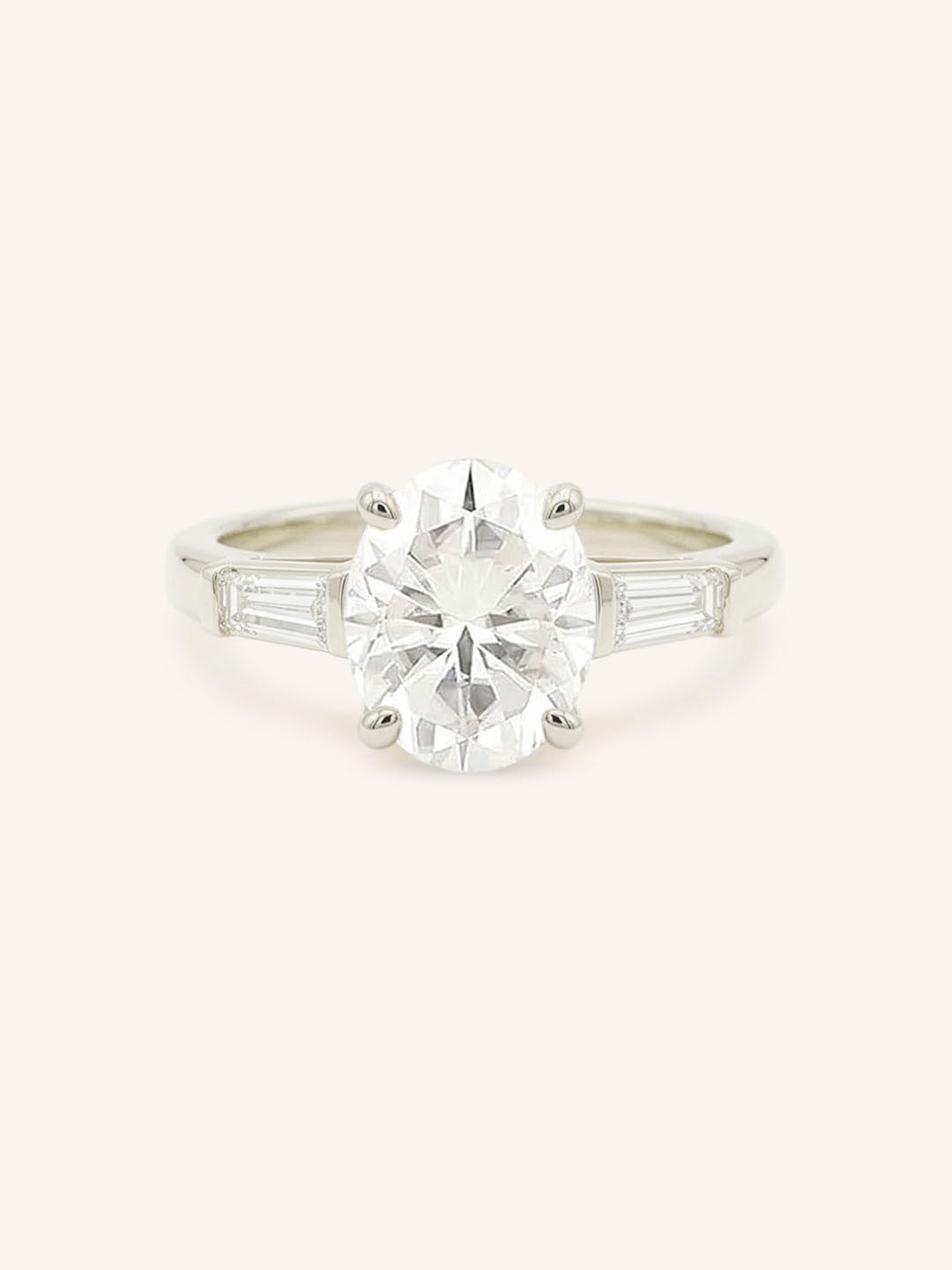 White gold Stately Manor oval diamond three stone engagement ring with baguette accents front view