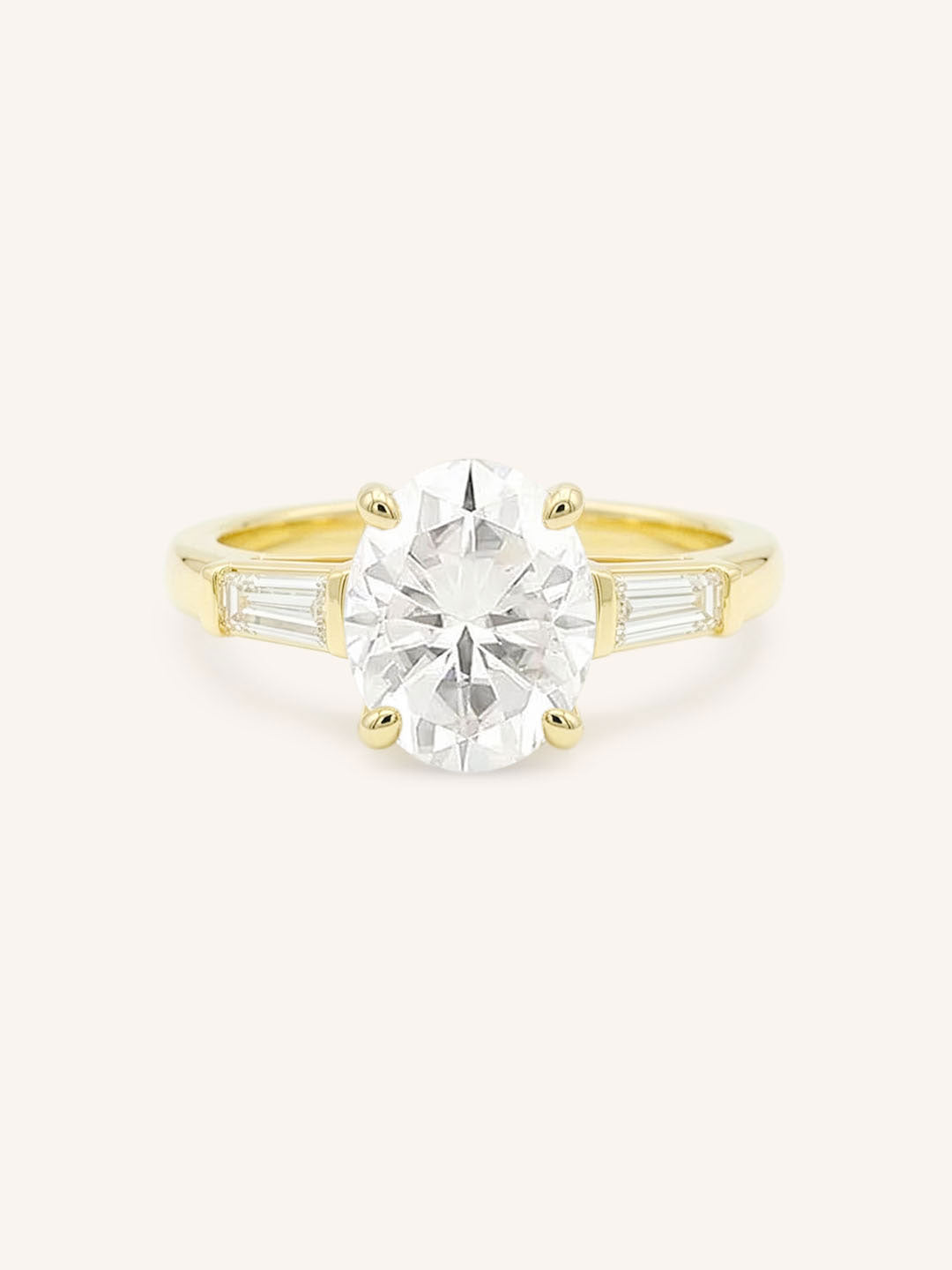 Yellow gold Stately Manor oval diamond three stone engagement ring with baguette accents front view