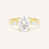 Yellow gold Stately Manor oval diamond three stone engagement ring with baguette accents front view