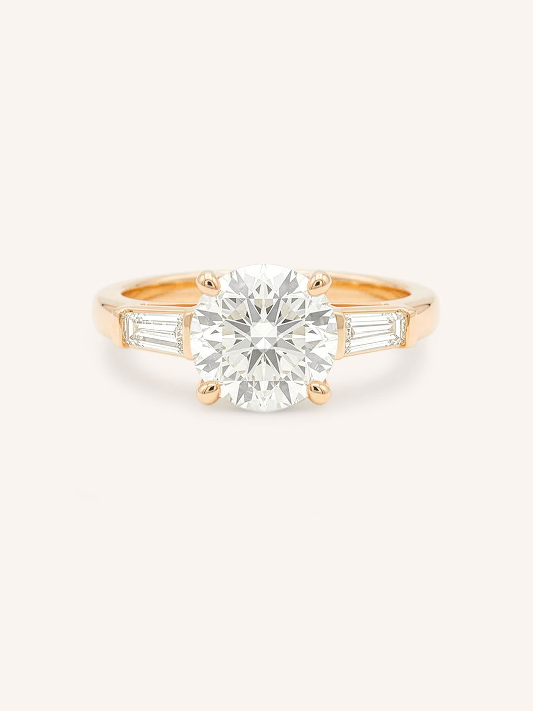 Rose gold Stately Manor round diamond three stone engagement ring with baguette accents front view